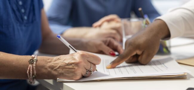 Middle aged woman signing retirement plan contract to secure the future income